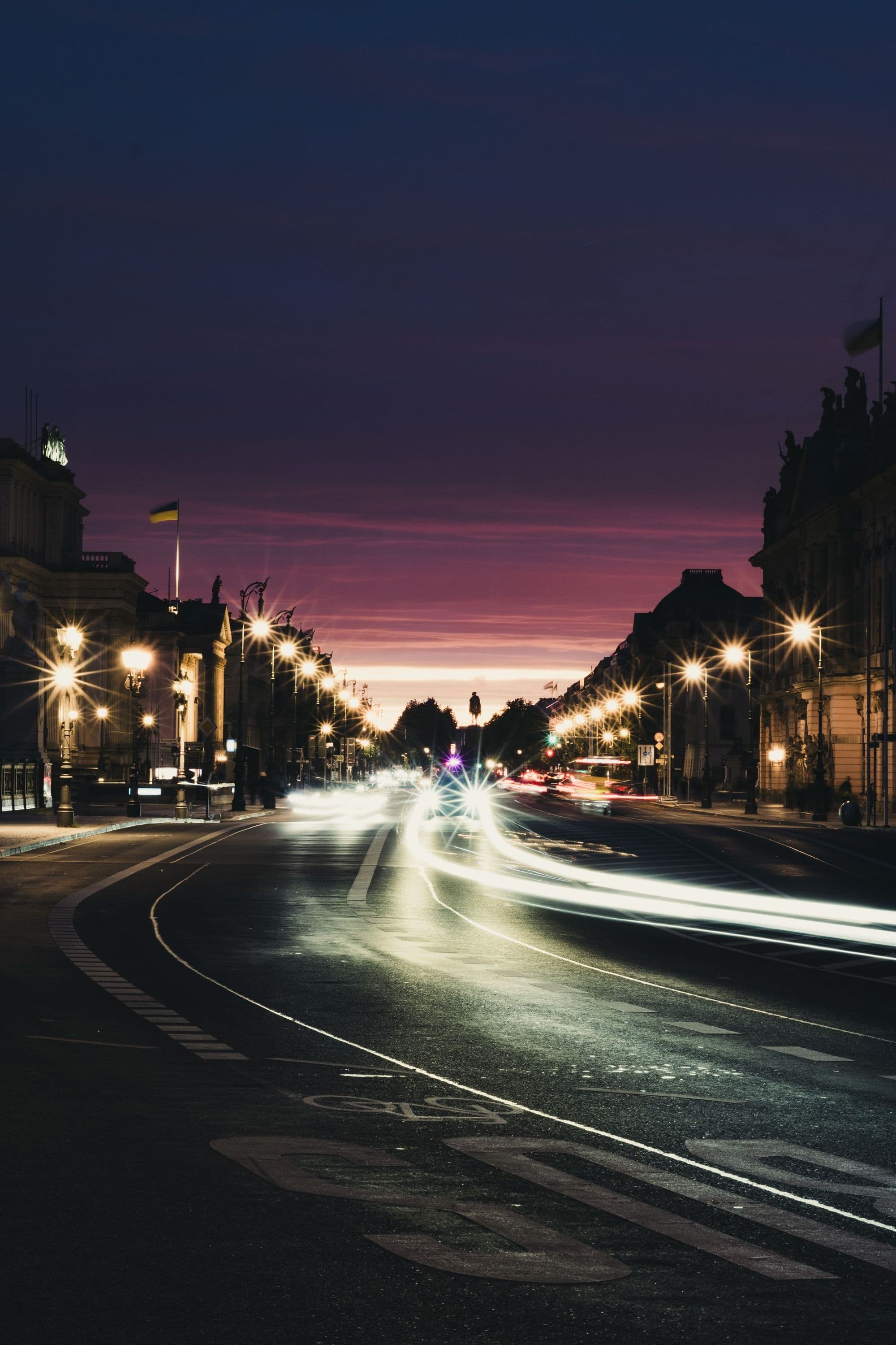 A city street at blue hour with light trails